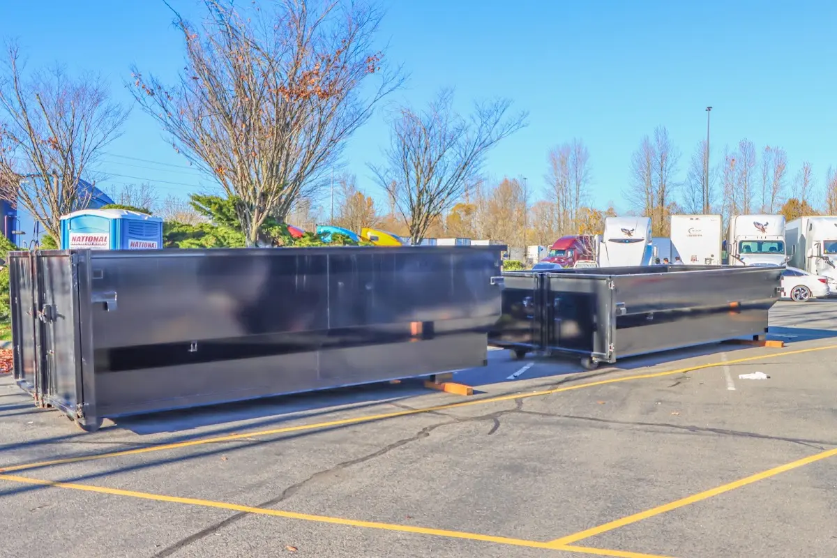 Professional dumpster rental service with roll-off container on residential driveway in Lenoir City